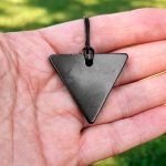 shungite pendant triangle in the hand