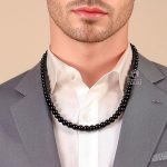 Man wearing black beaded shungite necklace