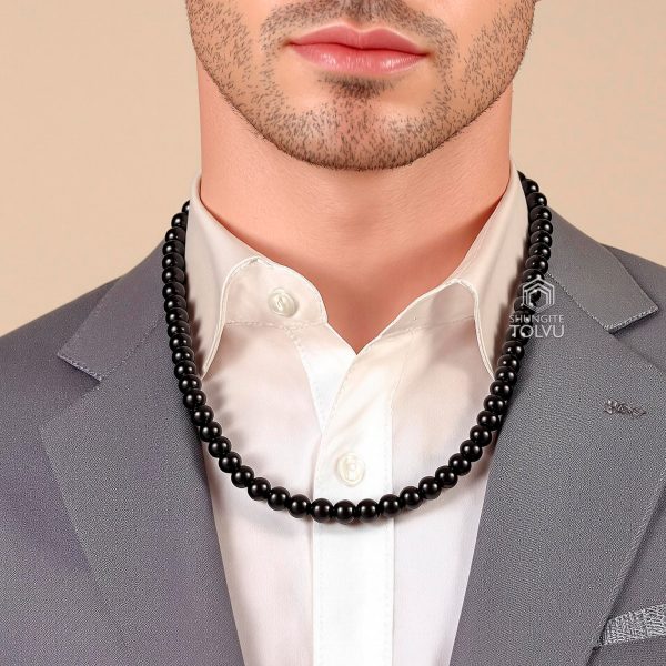 Man wearing black beaded shungite necklace