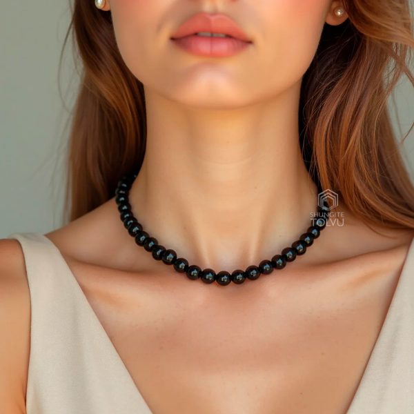 Woman wearing polished shungite beaded necklace