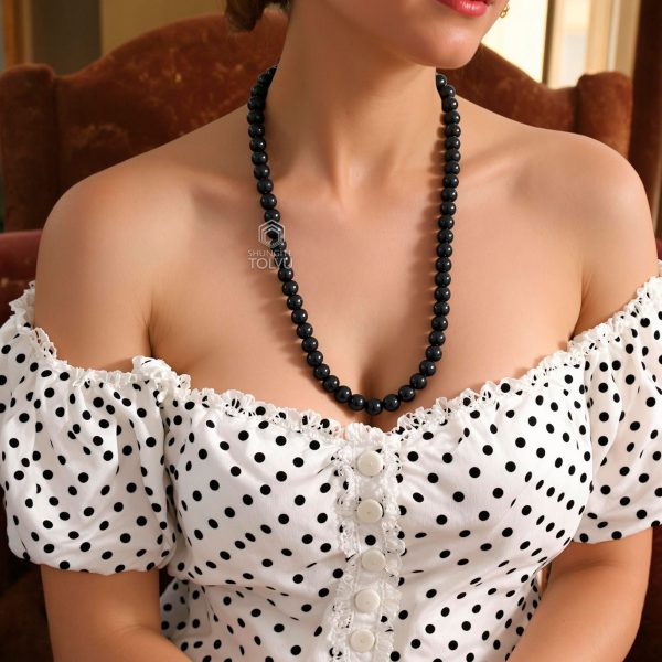 Black beads chain necklace worn by woman