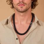 Black shungite necklace worn by man