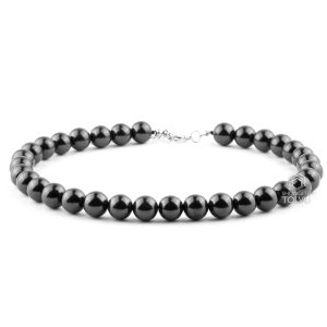 Large black bead necklace with 12mm shungite beads on decorative background