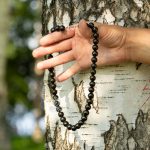 Black shungite bead necklace wrapped around wrist