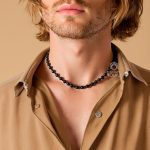 Black diamond bead necklace worn by man